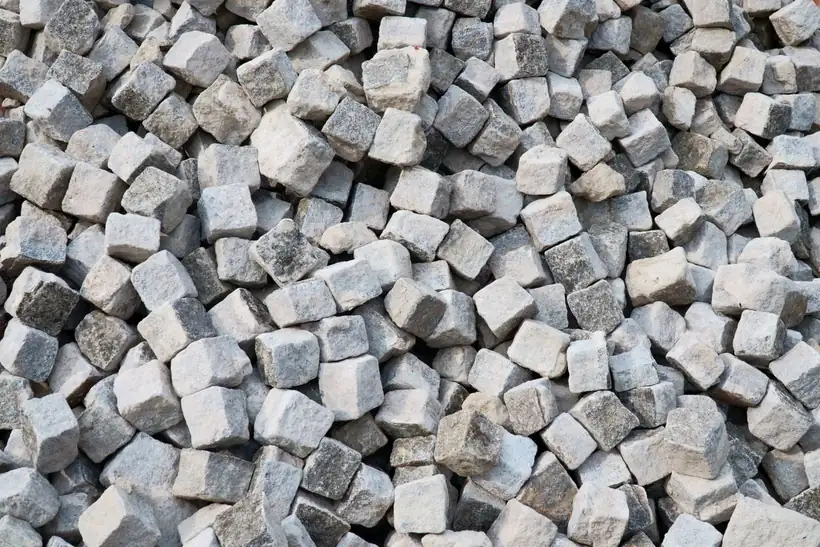 Granite setts stacked ready to be laid as a driveway edging course on a Middleton property