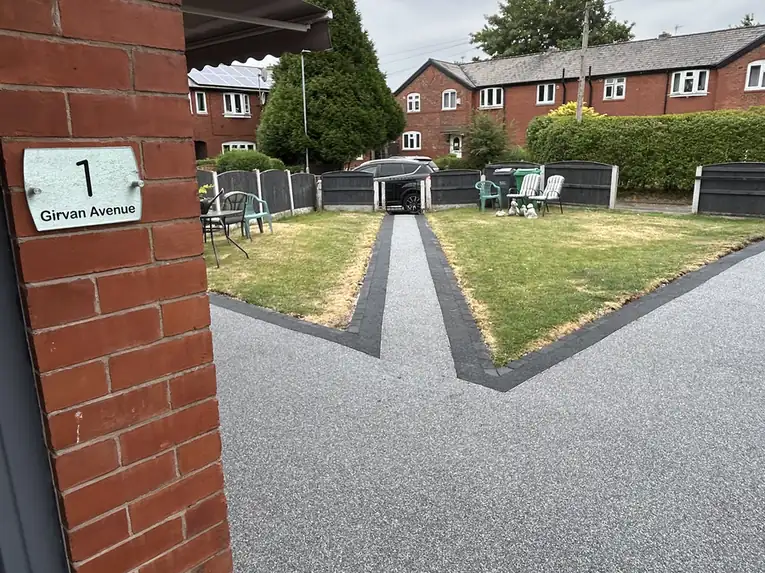 Dark grey resin bound driveway on a red brick terrace in North Manchester by S P Groundworks & Driveways