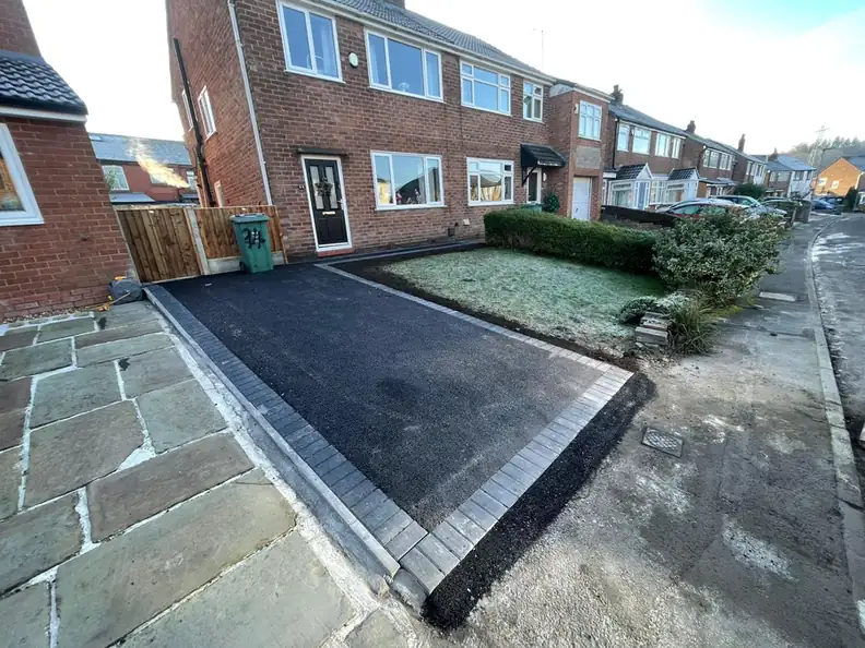 Tarmac driveway with a charcoal block soldier course on a brick semi in Middleton, laid by S P Groundworks & Driveways